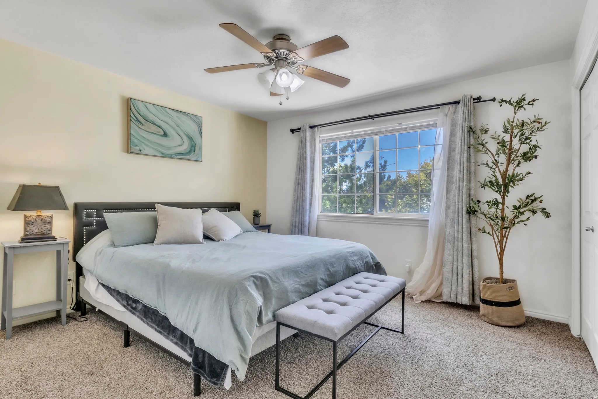 Bedroom featuring light carpet and ceiling fan