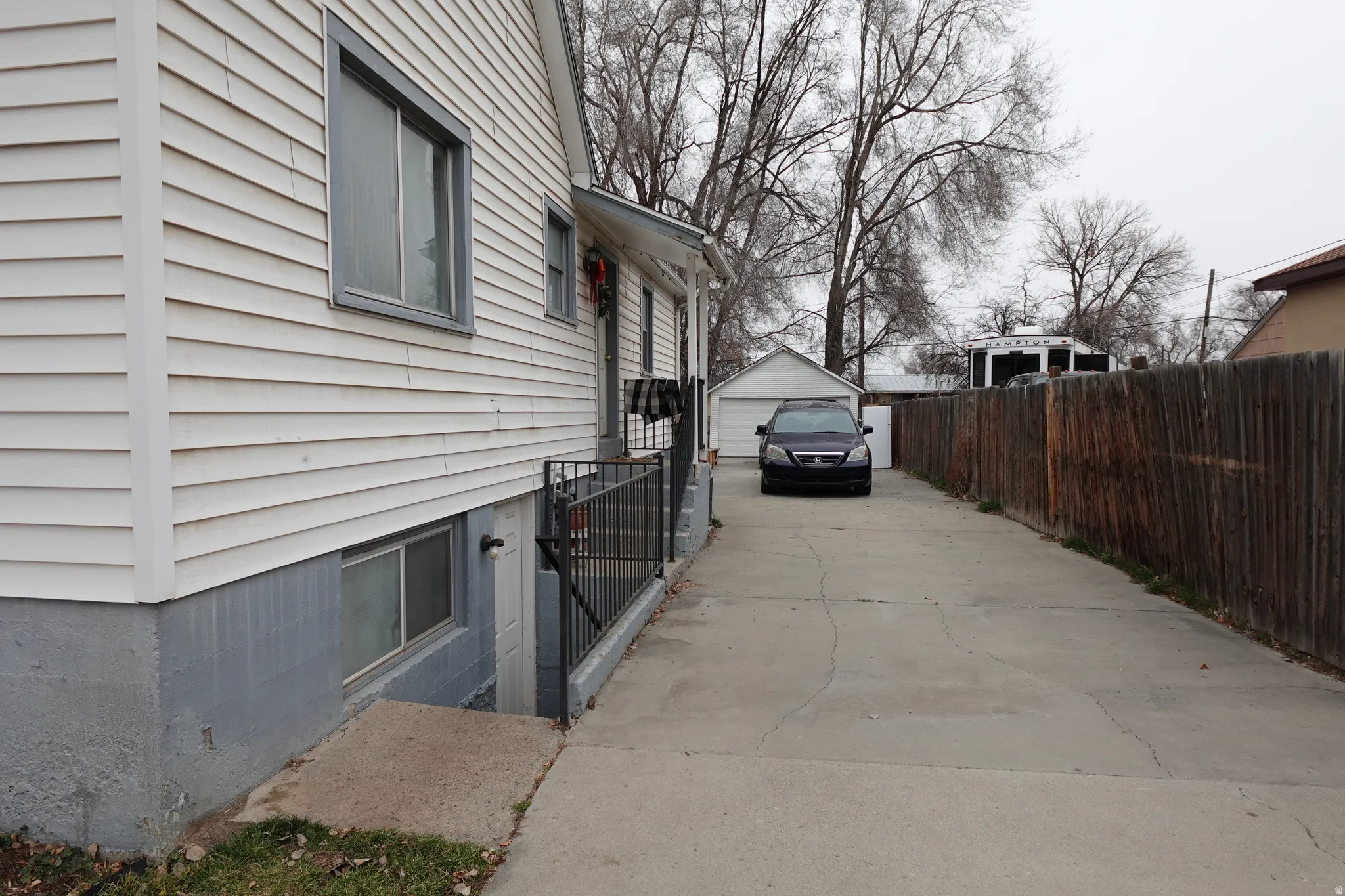 View of property exterior featuring a garage and an outdoor structure