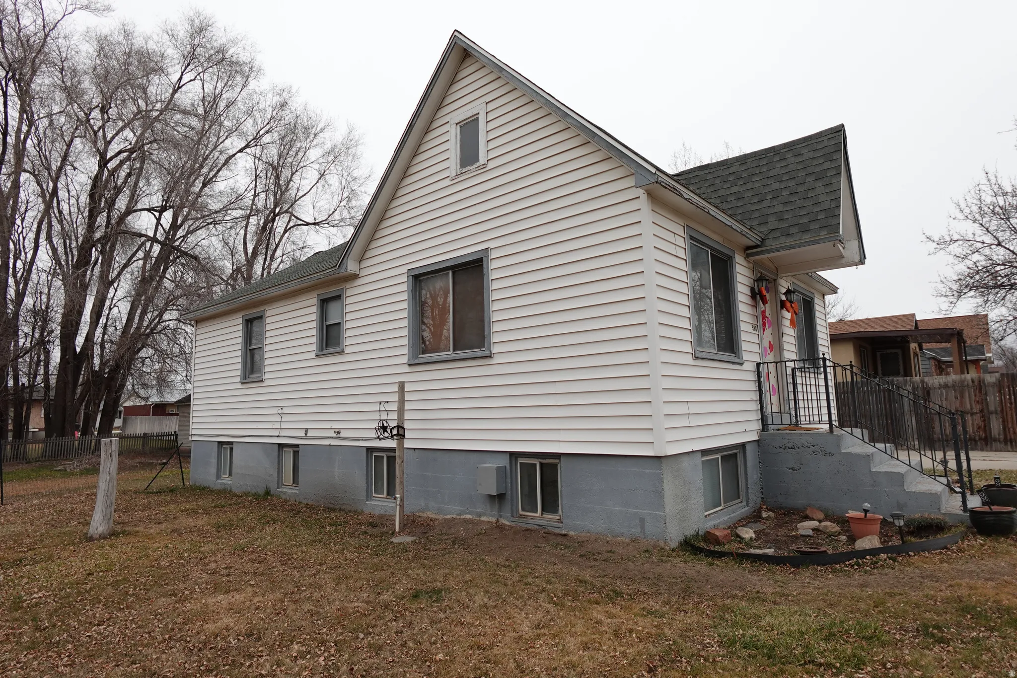 View of side of property with roof with shingles