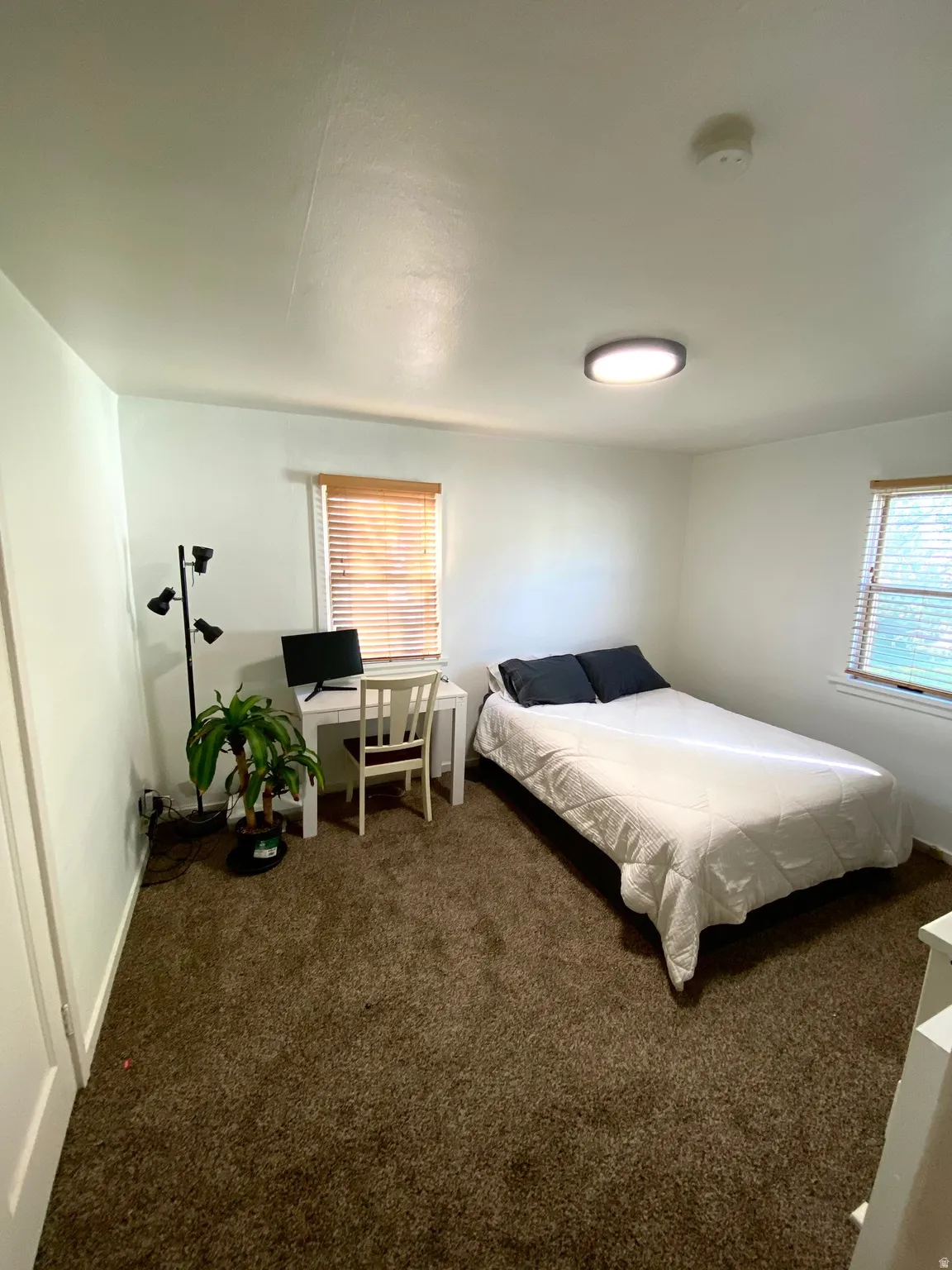 Carpeted bedroom featuring baseboards