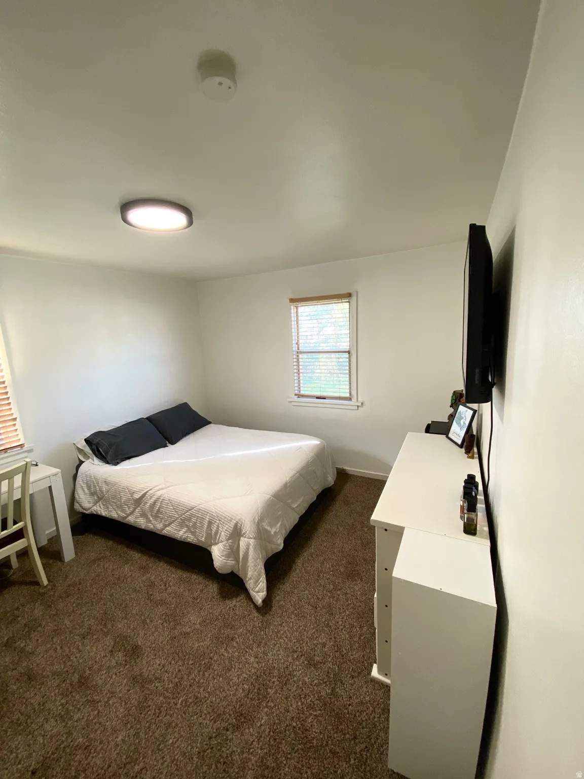 Bedroom with dark colored carpet
