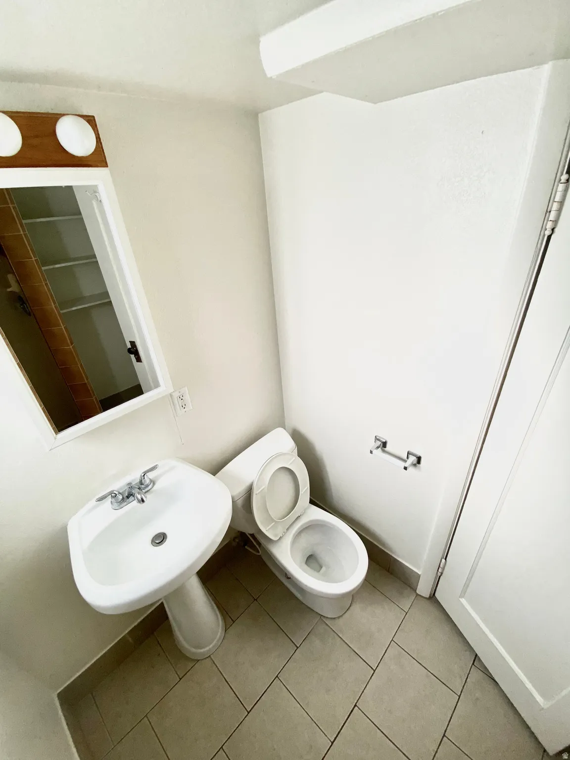 Bathroom featuring toilet and tile patterned floors
