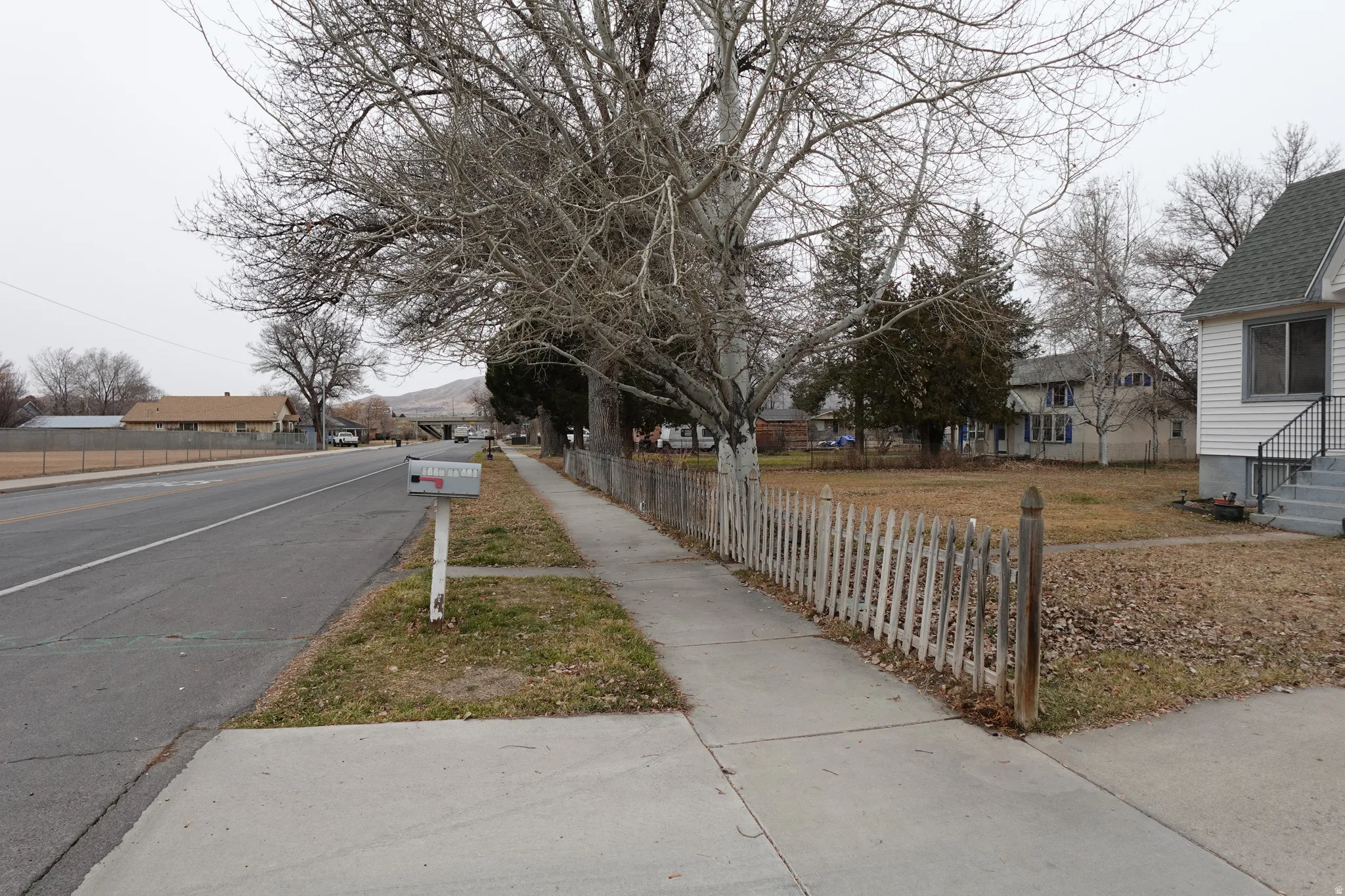 View of asphalt road with sidewalks and a residential view