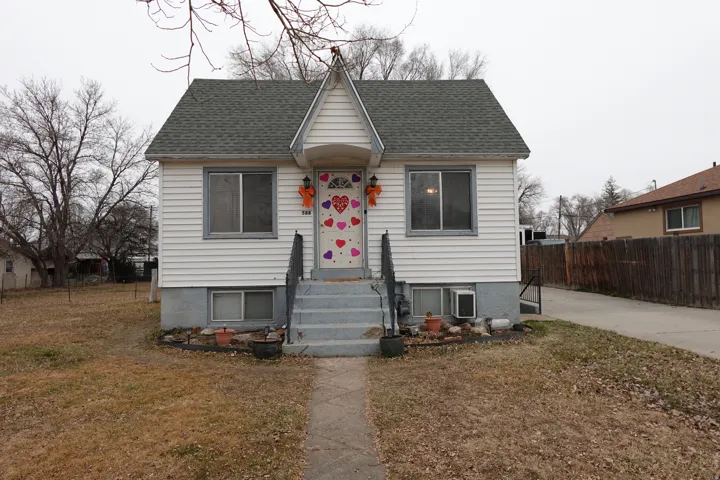Bungalow-style home with roof with shingles