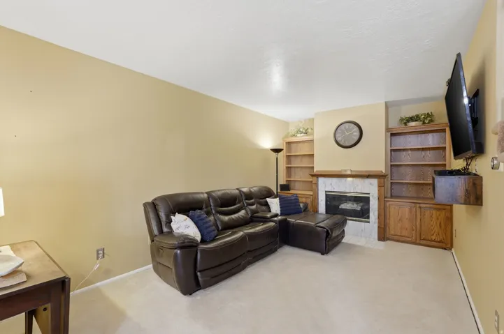 Living room with built in bookcase and fireplace.