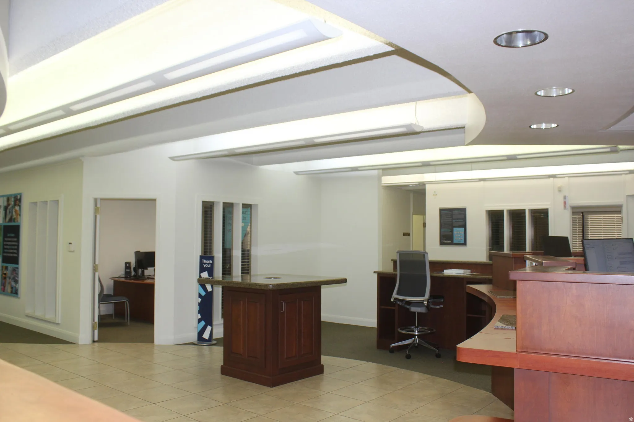 Office with recessed lighting and built in desk