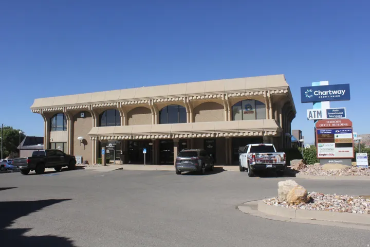View of commercial property featuring uncovered parking
