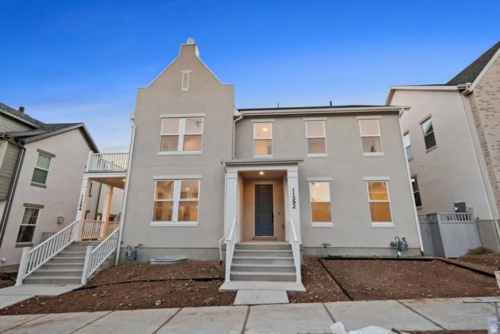 Traditional home featuring stucco siding