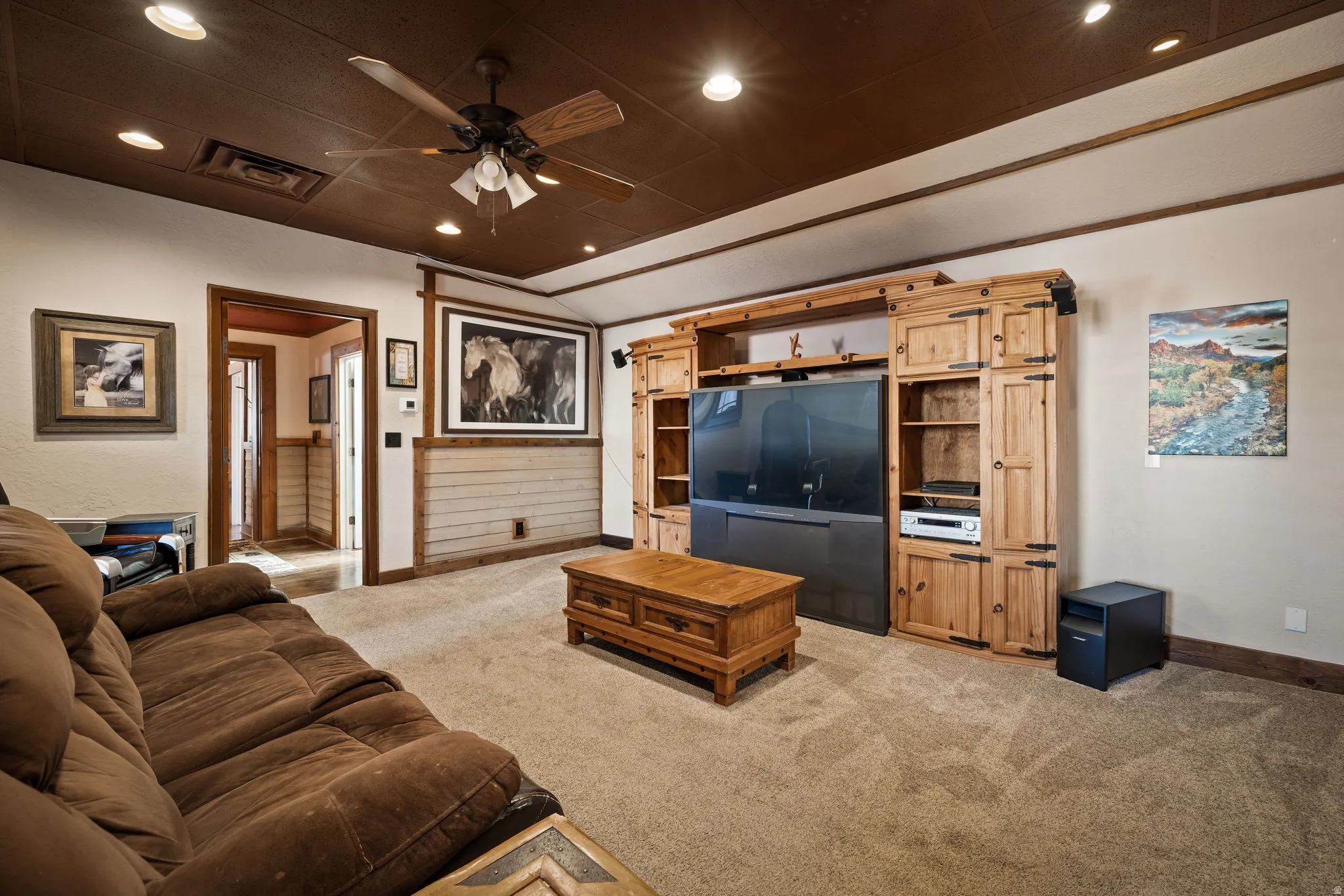 Living room featuring light colored carpet, recessed lighting, ceiling fan, and vaulted ceiling