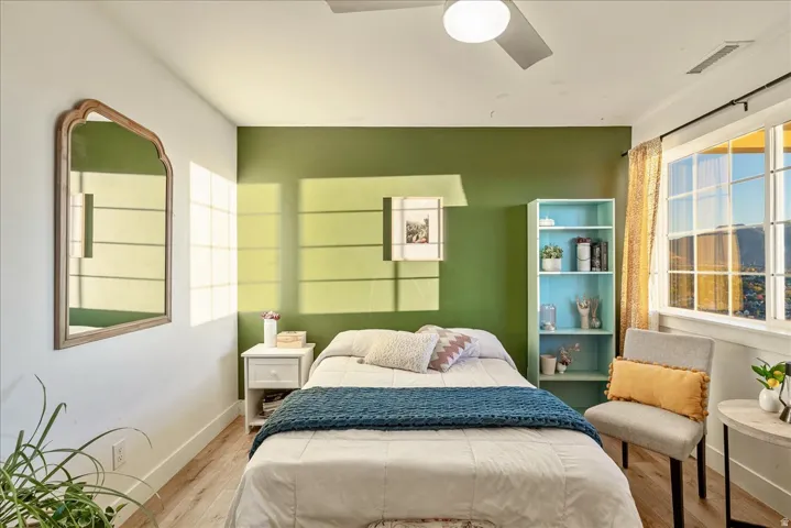 Bedroom featuring wood finished floors and ceiling fan