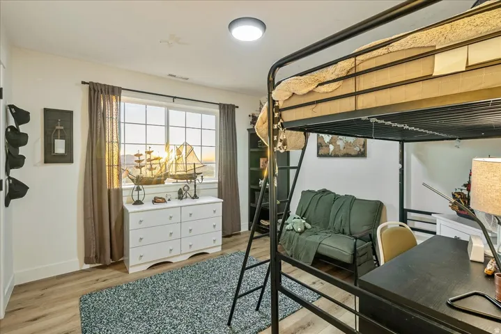 Bedroom with light wood-style flooring and baseboards