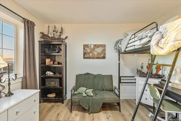 Bedroom featuring light wood-style flooring and baseboards