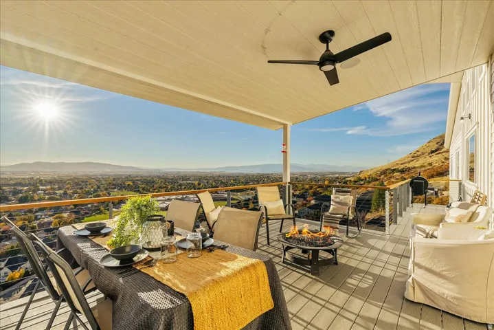View of patio / terrace with a mountain view, a ceiling fan, and outdoor dining space