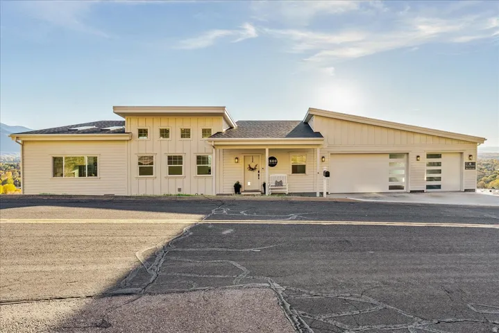 View of property with a garage and driveway
