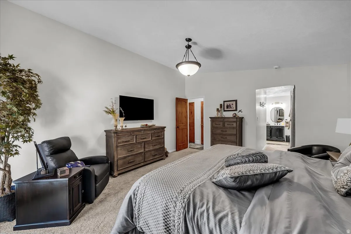 Bedroom with carpet flooring and ensuite bath