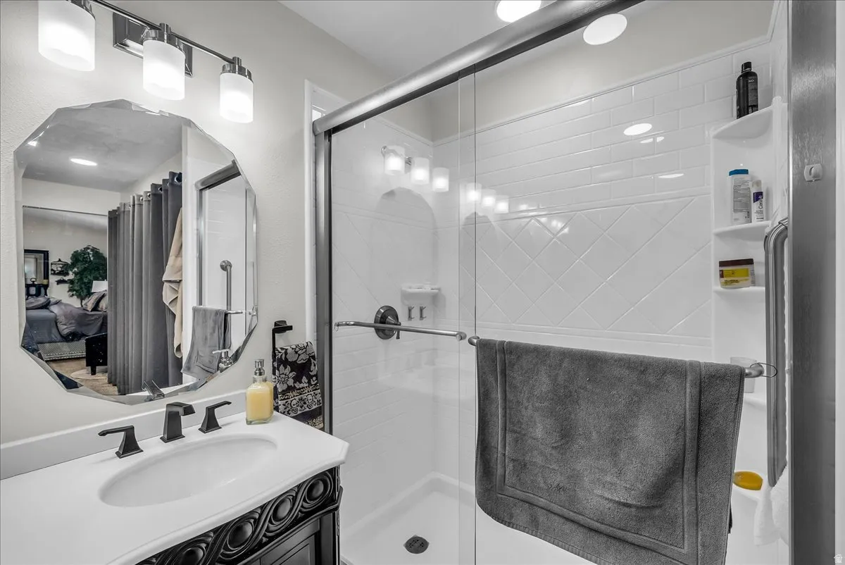 Full bathroom with vanity and a stall shower