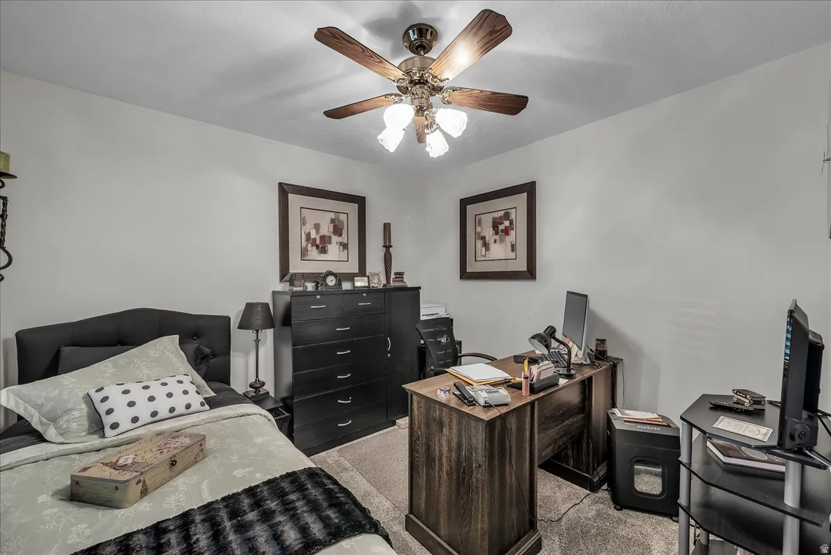 Home office featuring light colored carpet and ceiling fan