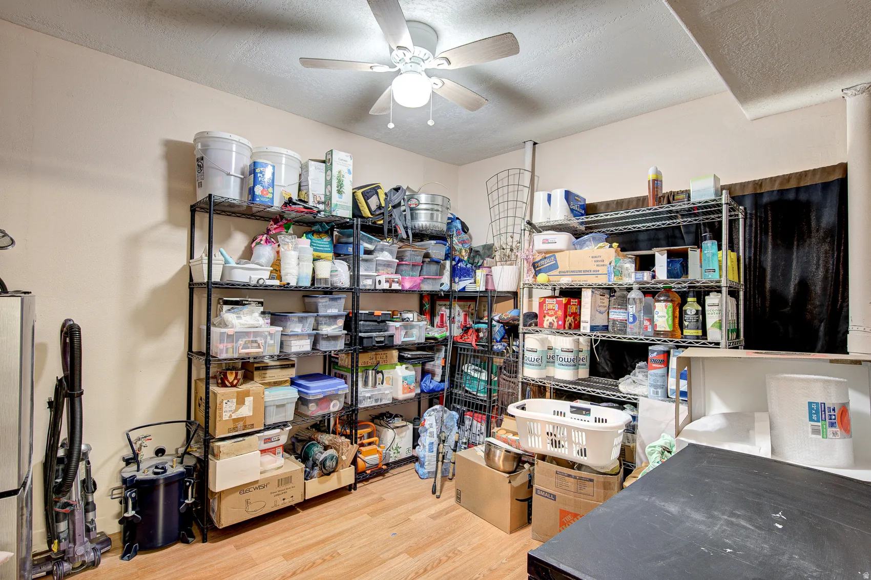 Storage area featuring a ceiling fan