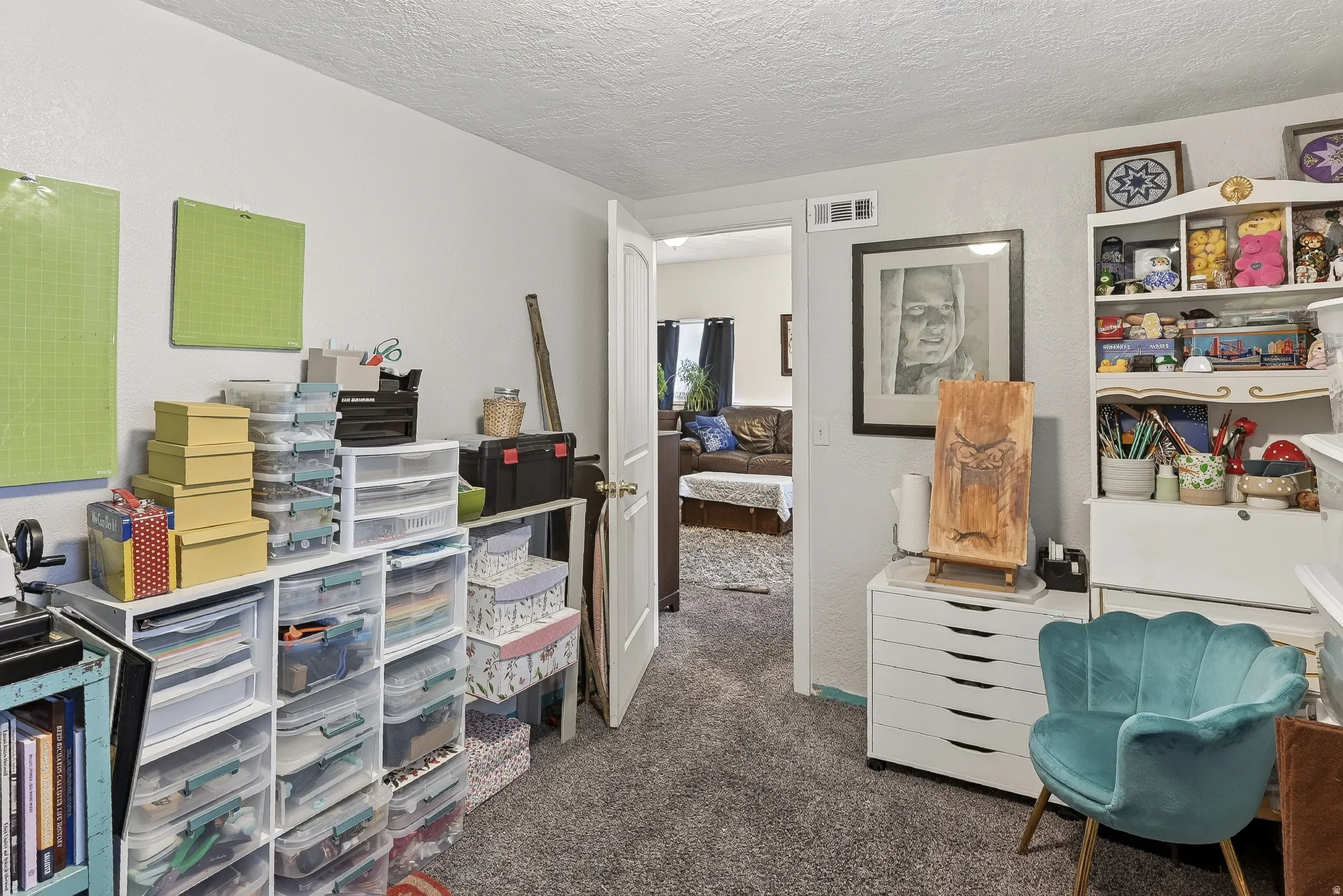 Office space with dark carpet, a textured ceiling, and a textured wall