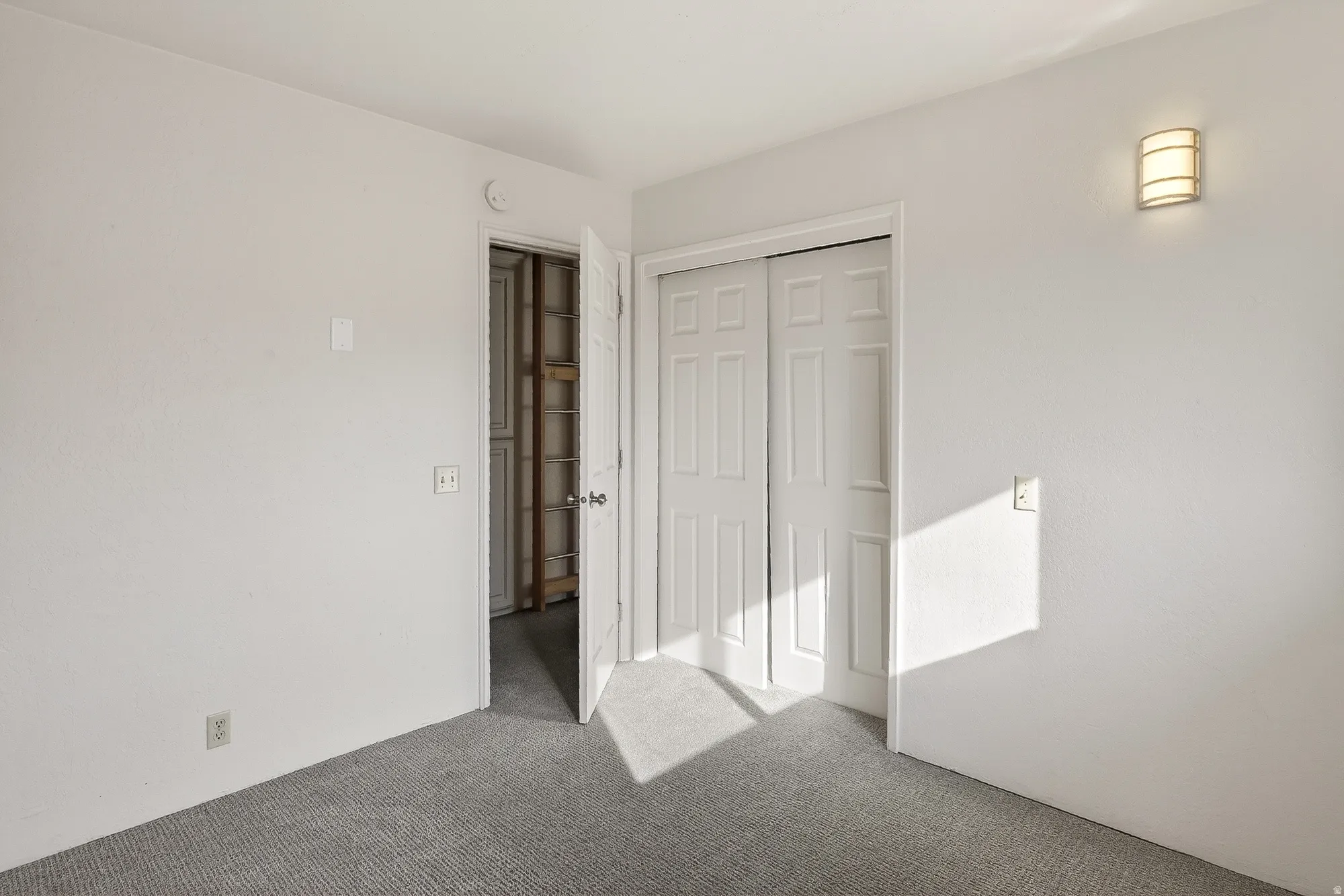 Unfurnished bedroom with carpet floors and a closet