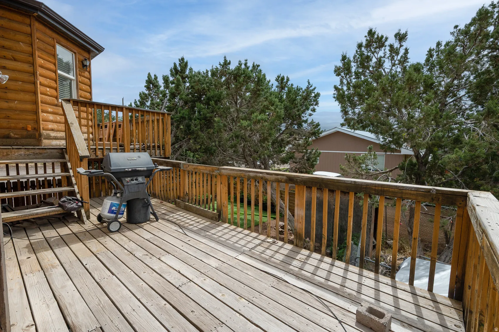 Wooden terrace featuring grilling area