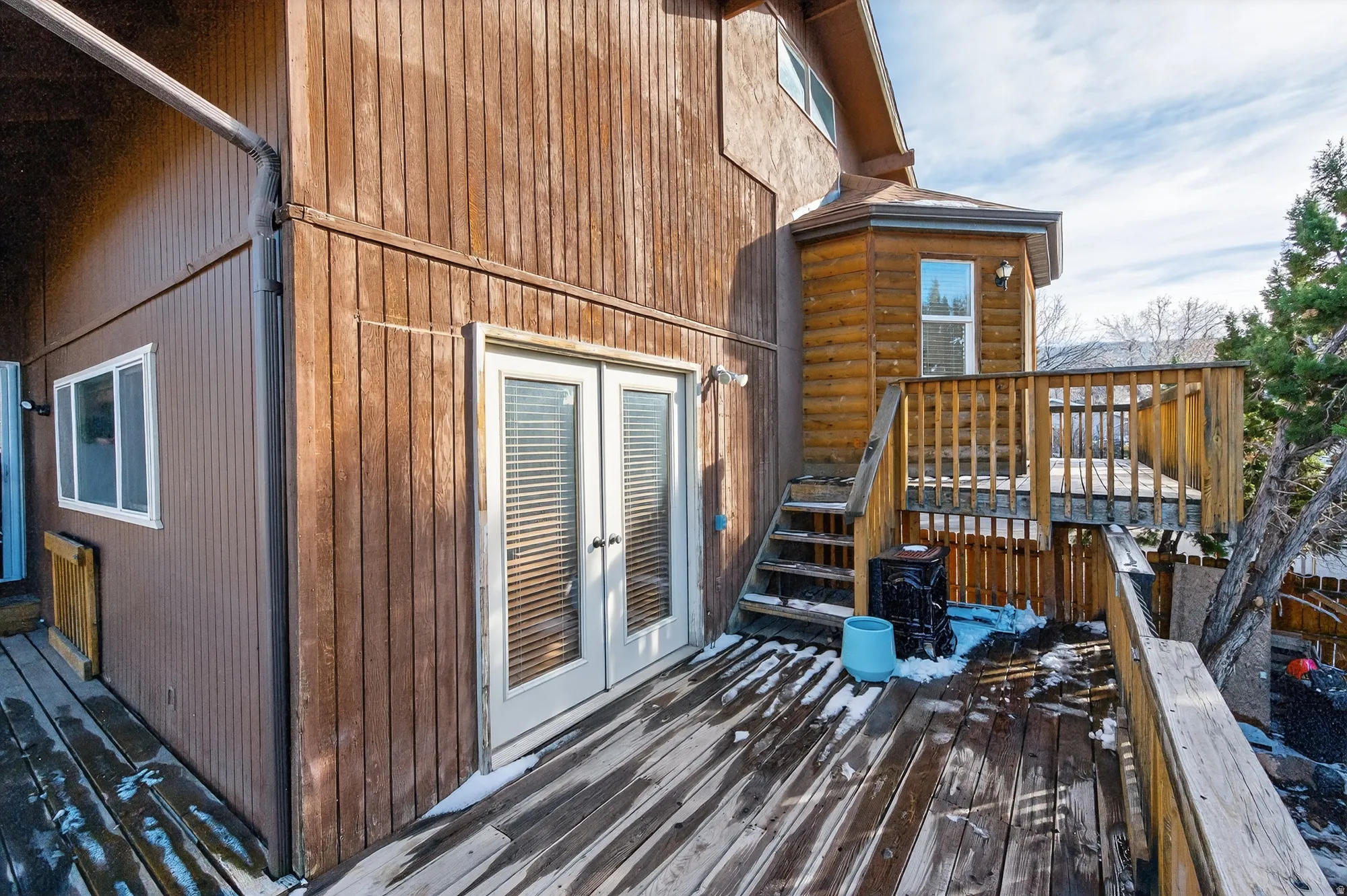 Wooden terrace featuring french doors