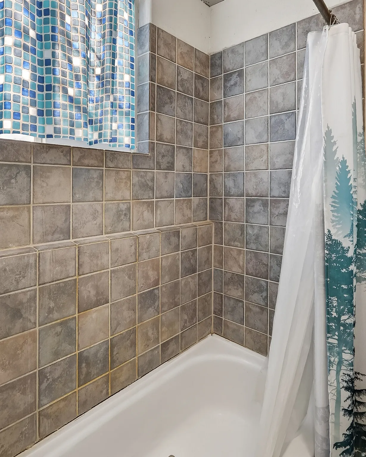 Full bathroom featuring shower / bathtub combination with curtain