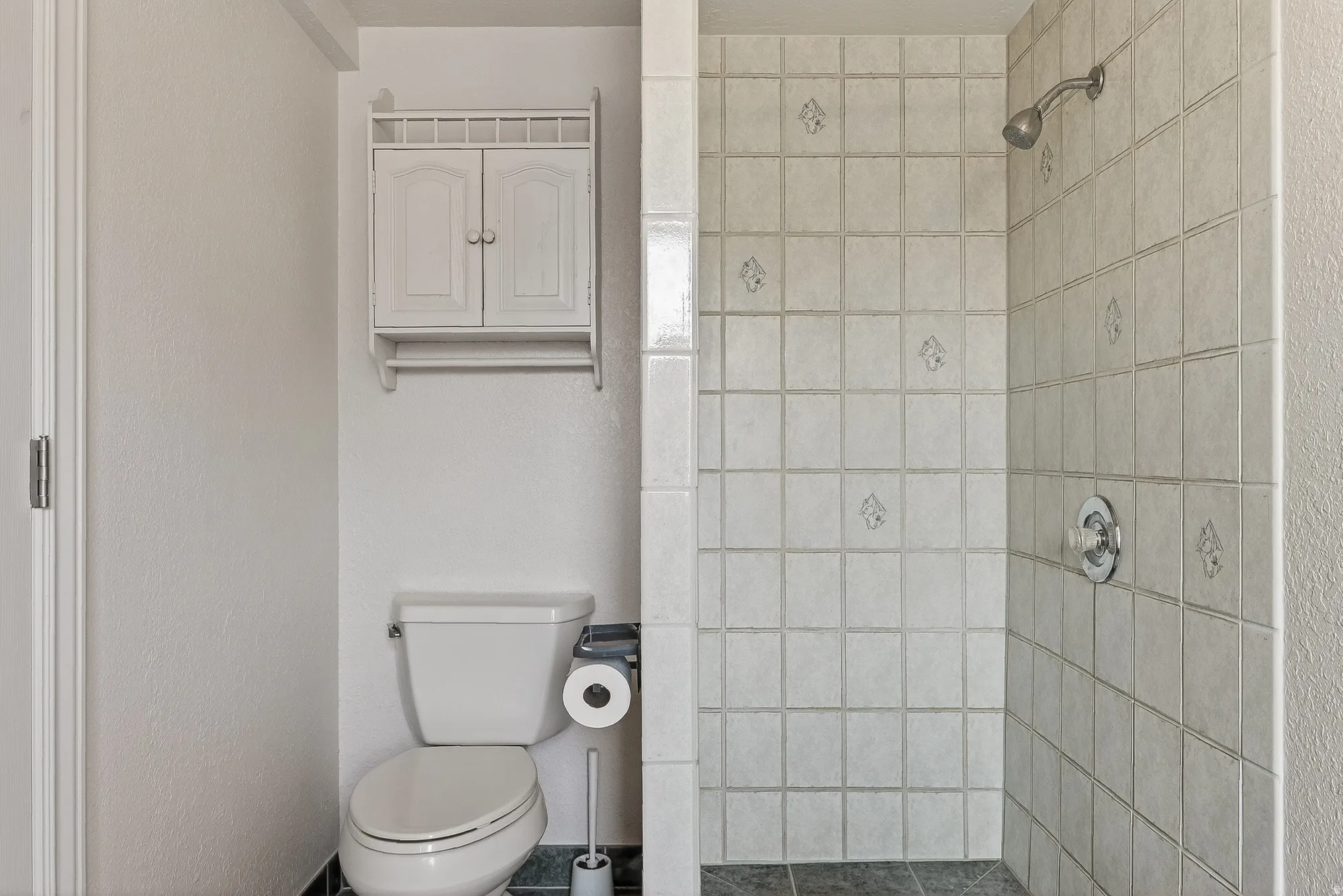 Full bath with a stall shower and toilet