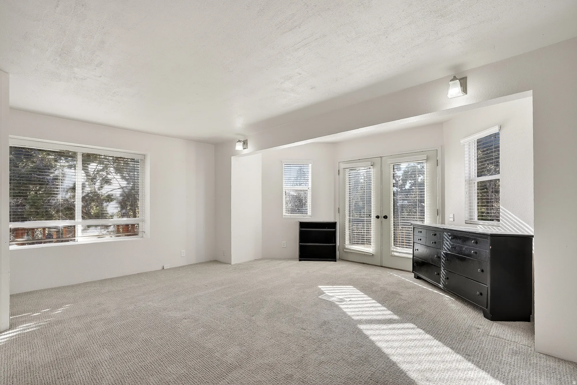 Unfurnished living room with french doors and carpet flooring