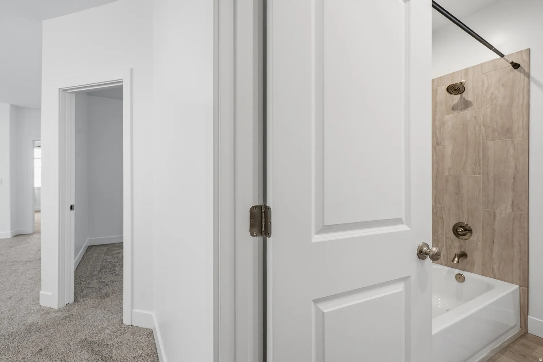 Full bath featuring baseboards and  shower combination