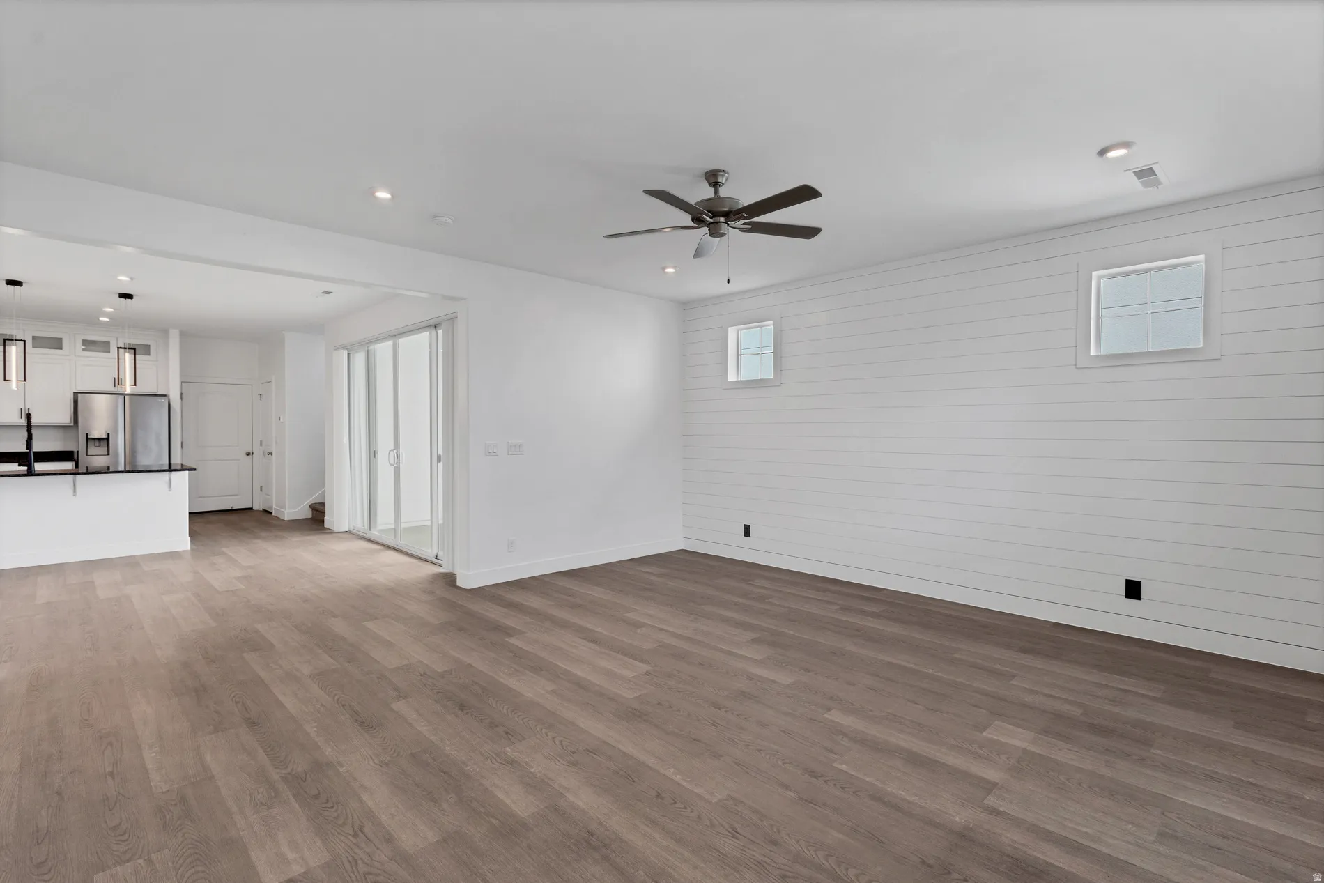 Wood-finish flooring, recessed lighting, and a ceiling fan