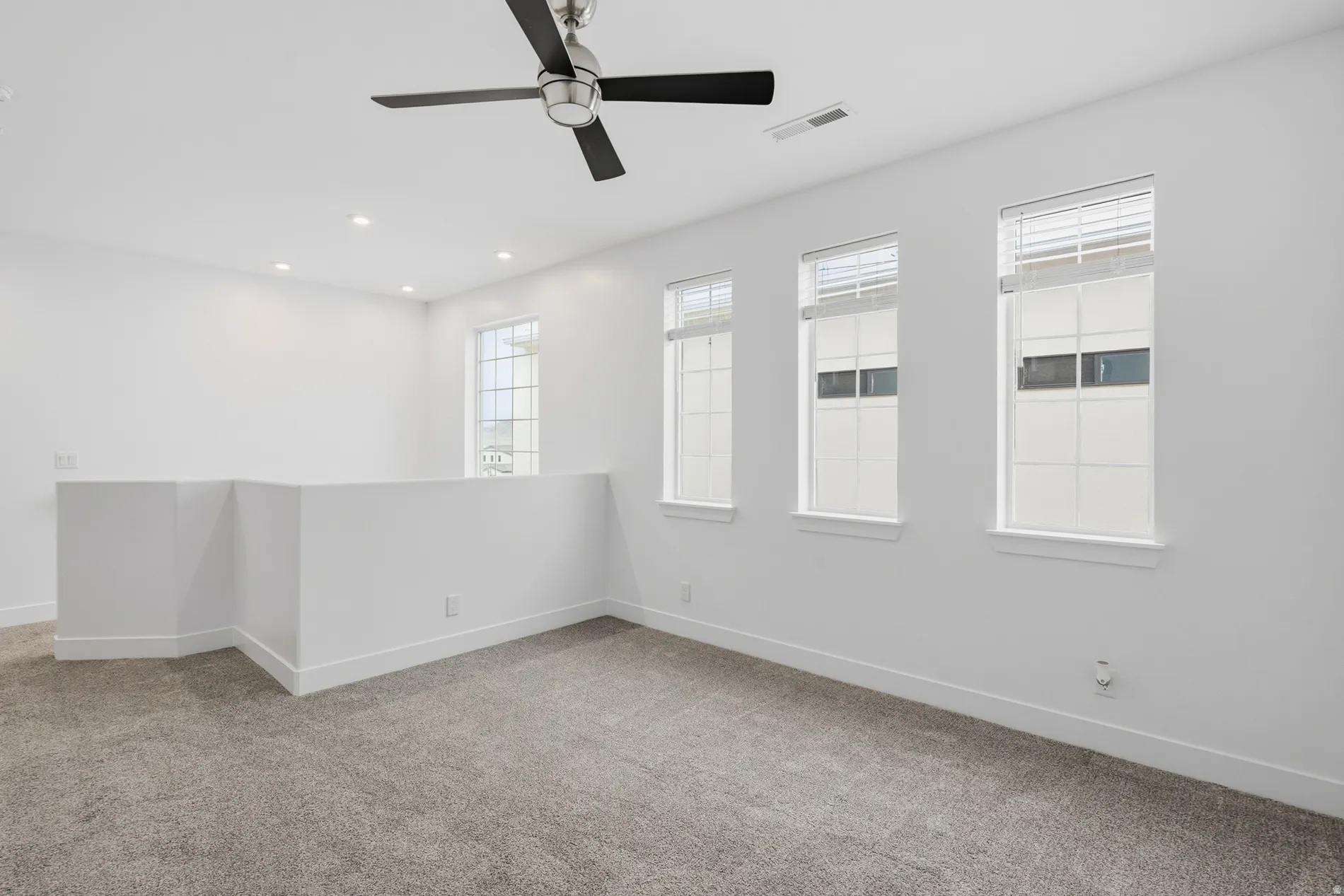 Spare room with light carpet, a ceiling fan, and recessed lighting