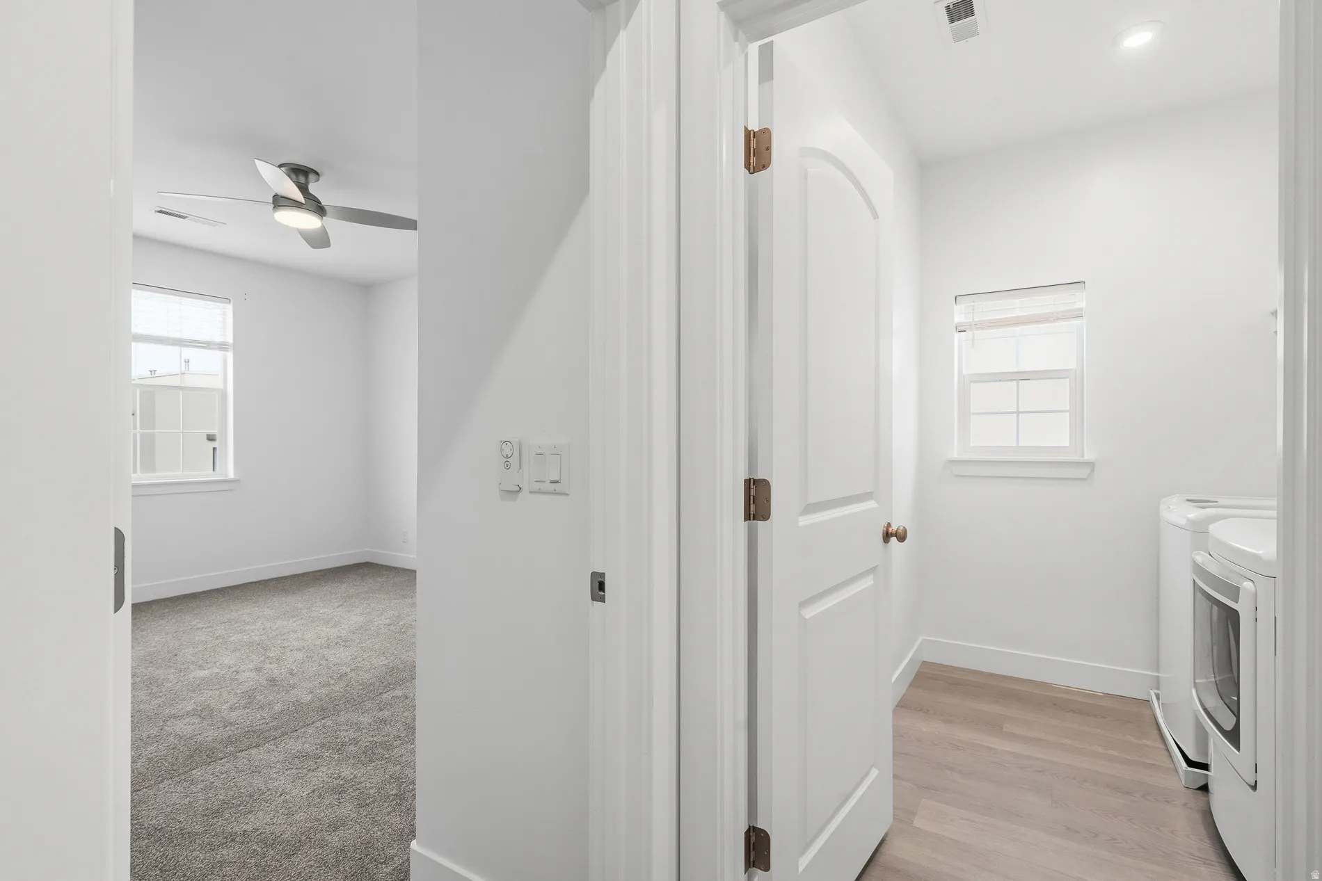 Washroom featuring washing machine and dryer, ceiling fan, light wood-style flooring, and recessed lighting