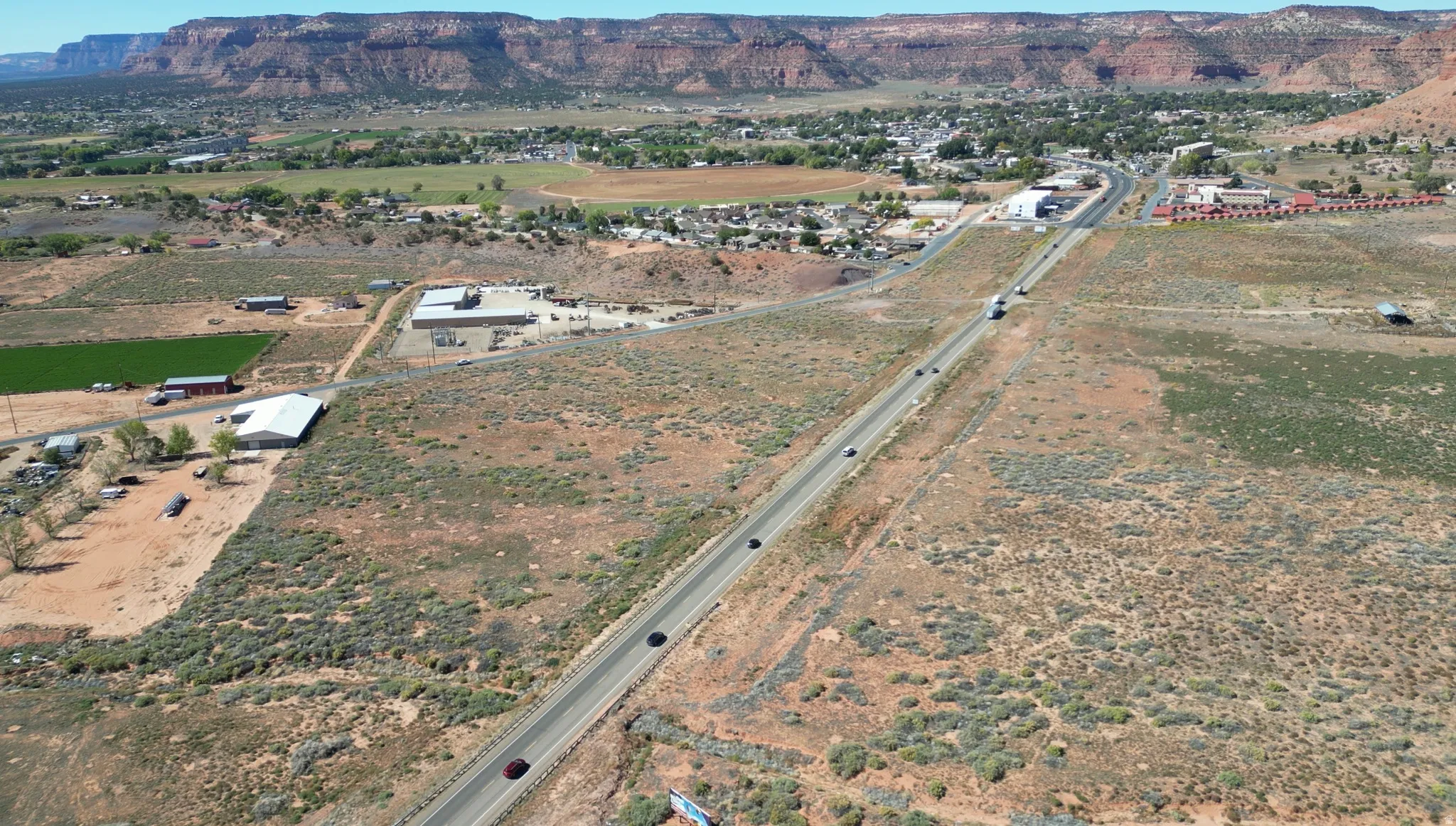 Aerial view of property's location featuring a mountain backdrop and rural landscape