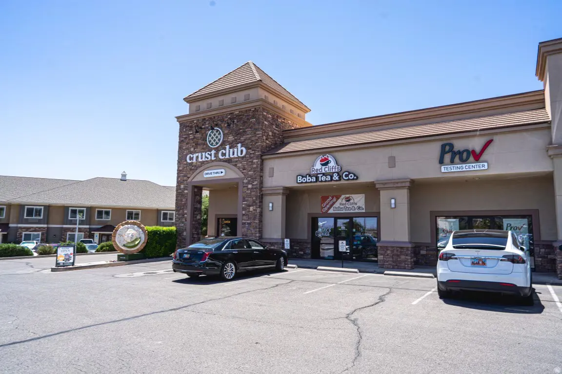 View of building exterior with uncovered parking