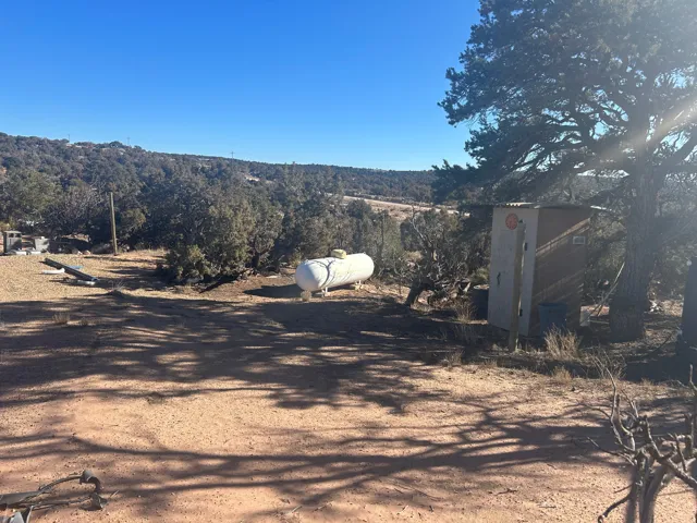 View of dirt / gravel road featuring a view of rural / pastoral area