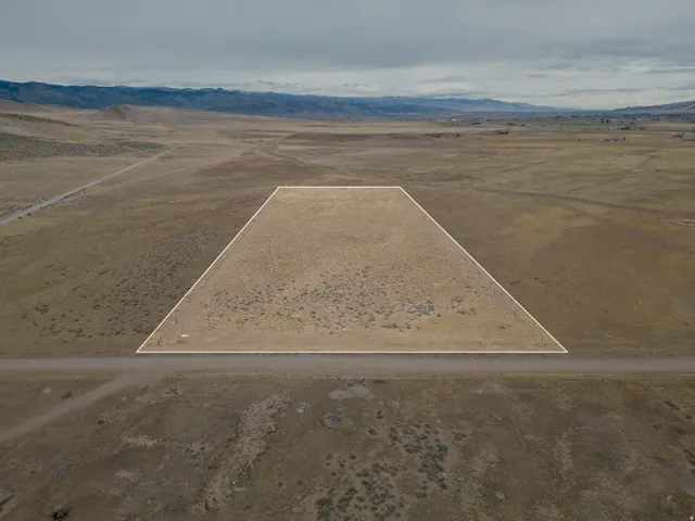 Aerial view of sparsely populated area with a desert landscape and a mountainous background