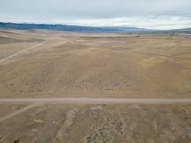 Overview of rural landscape featuring a desert landscape and a mountain backdrop