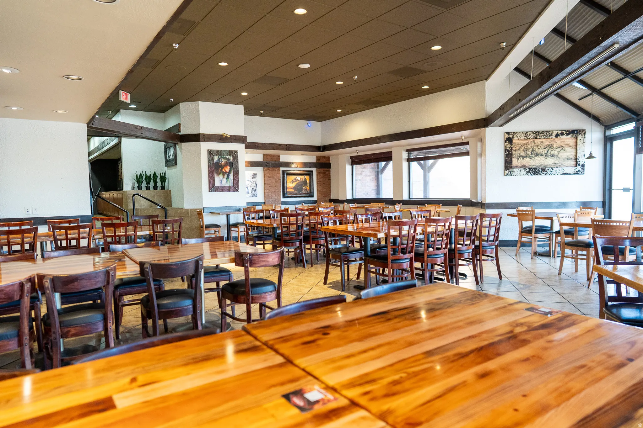 Dining area featuring a high ceiling, recessed lighting, and light tile patterned flooring
