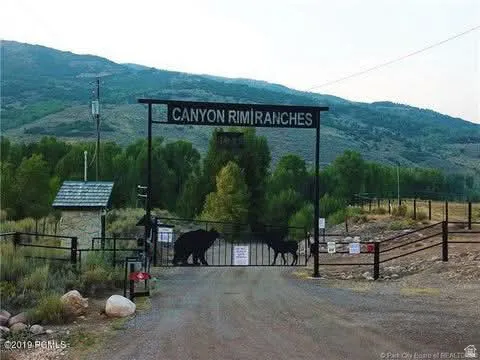 Surrounding community with a mountain view, a gate, and a view of countryside