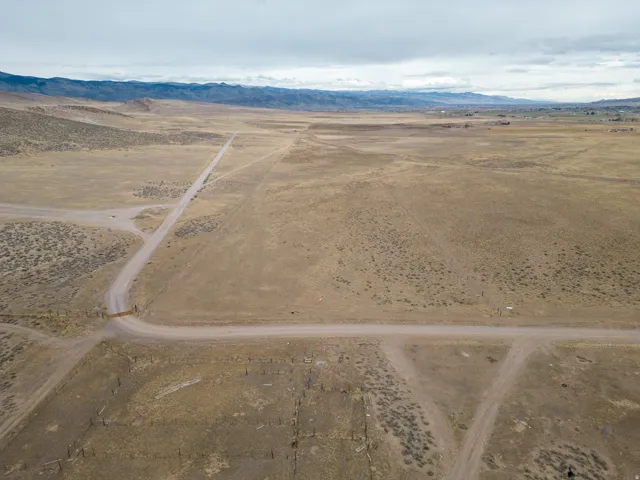 Overview of rural landscape featuring a desert landscape and a mountainous background
