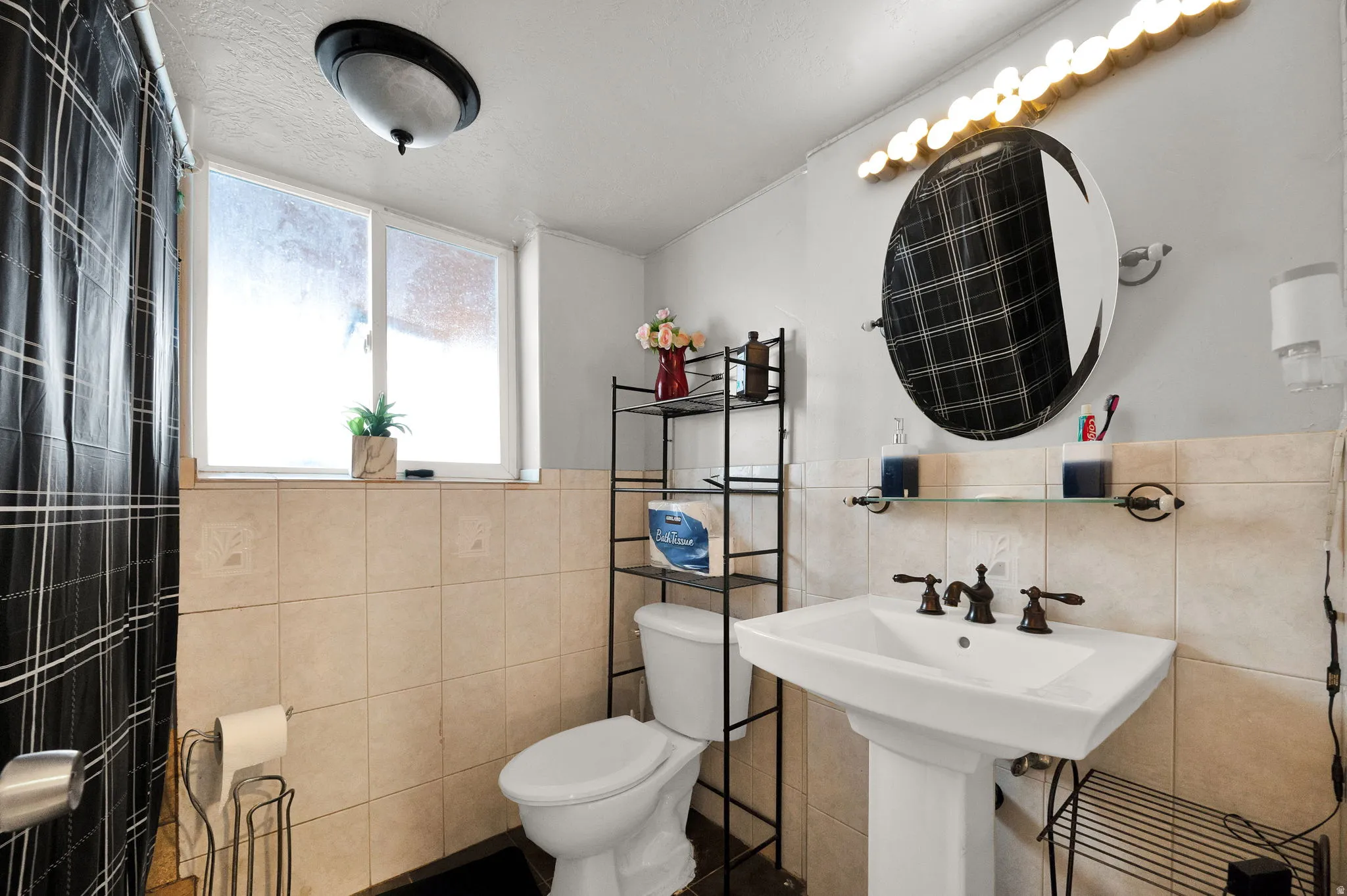Bathroom featuring tile walls and wainscoting