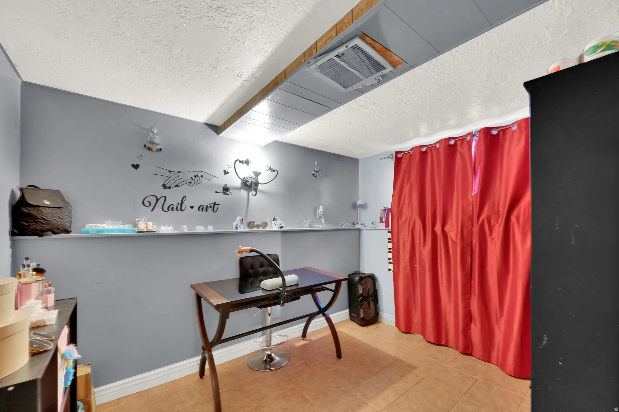 Office area featuring a textured ceiling and baseboards