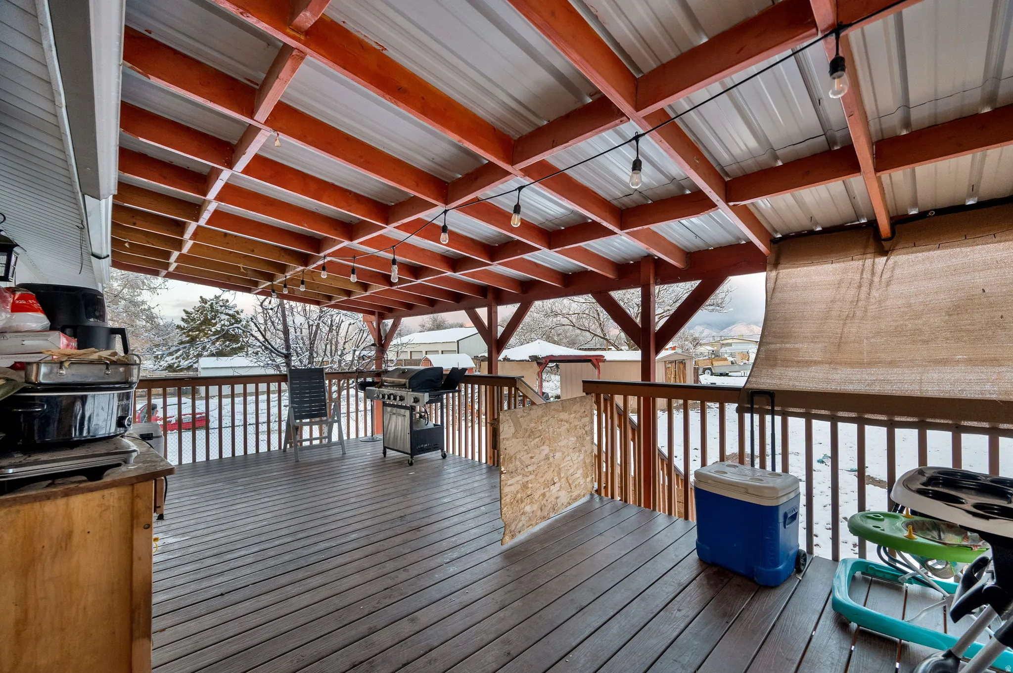 Snow covered deck featuring area for grilling