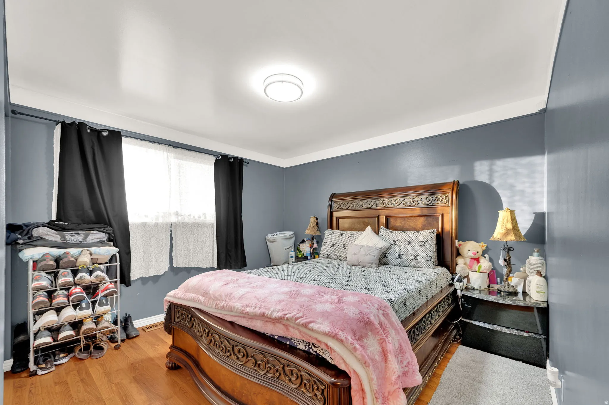 Bedroom featuring wood finished floors and baseboards