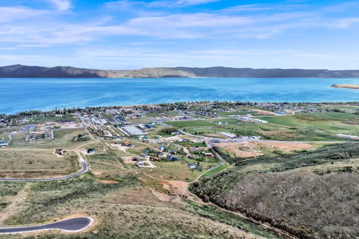Expansive aerial perspective showcasing a significant body of water bordered by mountainous terrain