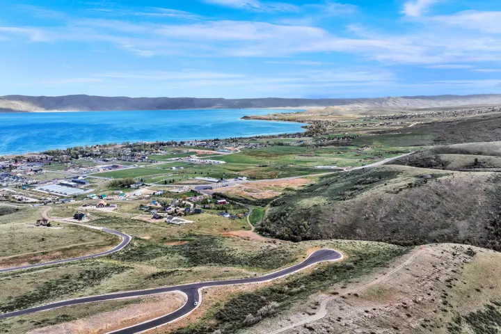 Expansive land parcel featuring natural topography, paved roadways, and partially developed areas