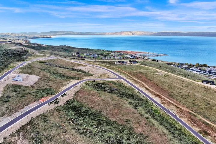Expansive undeveloped land with paved roads and distant lake frontage