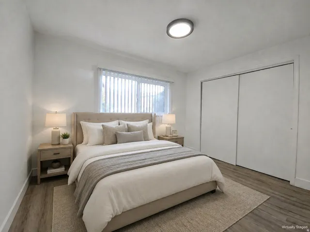 Recessed lighting, wood-finish flooring, and white walls
