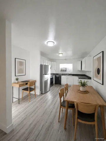 Open-concept living area with wood-finish flooring